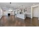 Open concept living space with island, fireplace, and lots of natural light at 137 Alderbranch Cir, Garner, NC 27529