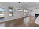 Bright living room with hardwood floors, large windows, fireplace, and modern chandelier at 137 Alderbranch Cir, Garner, NC 27529