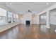 Bright living room features hardwood floors, fireplace, and many windows at 137 Alderbranch Cir, Garner, NC 27529