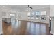 Open concept living space with hardwood floors, modern lighting, and lots of natural light at 137 Alderbranch Cir, Garner, NC 27529