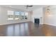 Bright living room featuring a fireplace, ceiling fan, and multiple windows at 137 Alderbranch Cir, Garner, NC 27529