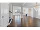 Open-concept living room with hardwood floors, white trim, and a fireplace at 137 Alderbranch Cir, Garner, NC 27529