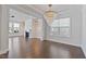 Bright living room features hardwood floors, a modern chandelier, and an elegant fireplace at 137 Alderbranch Cir, Garner, NC 27529
