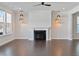 Spacious living room with hardwood floors, fireplace, and modern pendant lighting at 137 Alderbranch Cir, Garner, NC 27529