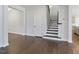 Entry way with staircase featuring dark hardwood and neutral walls at 137 Alderbranch Cir, Garner, NC 27529