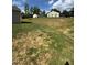 Large, mostly grassy backyard with some dirt patches at 159 Bywood Dr, Roxboro, NC 27573