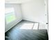 Bright bedroom with a window and wood-look flooring at 159 Bywood Dr, Roxboro, NC 27573