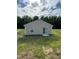 Tan house with sliding glass door and grassy backyard at 159 Bywood Dr, Roxboro, NC 27573