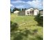 Tan house with red door and attached garage, on a grassy lot at 159 Bywood Dr, Roxboro, NC 27573