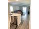 Open concept kitchen and living area with gray sectional sofa and hardwood floors at 159 Bywood Dr, Roxboro, NC 27573