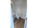 Powder room with pedestal sink, elongated toilet, and wood-look flooring at 203 Broomgrove Way, Wake Forest, NC 27587