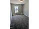 Bedroom with neutral carpet, walls, trim, and a window at 203 Broomgrove Way, Wake Forest, NC 27587