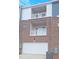 Exterior view of a three-story townhouse with a garage and two balconies at 203 Broomgrove Way, Wake Forest, NC 27587