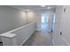 Upstairs hallway featuring carpeted floors, neutral-colored walls, and multiple entryways at 203 Broomgrove Way, Wake Forest, NC 27587