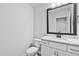 Well-lit bathroom features a modern vanity with a sleek mirror, marble countertop, and a toilet at 2094 Harris Farm Ct, Burlington, NC 27215
