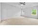 Bright bedroom features a tray ceiling, ceiling fan, and carpeted floors for a comfortable retreat at 2094 Harris Farm Ct, Burlington, NC 27215