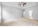 Spacious bedroom featuring a ceiling fan, tray ceiling and an ensuite bathroom at 2094 Harris Farm Ct, Burlington, NC 27215