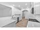 Modern, open-concept kitchen with white cabinets, stainless appliances, and light hardwood flooring at 2094 Harris Farm Ct, Burlington, NC 27215