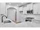 Bright white kitchen featuring stainless steel appliances, quartz countertops, and a stylish backsplash at 2094 Harris Farm Ct, Burlington, NC 27215