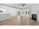 Open concept living room with fireplace and access to backyard and adjacent kitchen area at 2094 Harris Farm Ct, Burlington, NC 27215