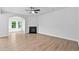 Spacious living room with hardwood floors, fireplace, and large windows for lots of natural light at 2094 Harris Farm Ct, Burlington, NC 27215