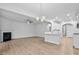 Open-concept living area with fireplace, wood flooring, and adjacent white kitchen at 2094 Harris Farm Ct, Burlington, NC 27215