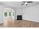 Bright and spacious living room with hardwood floors, fireplace, and large windows with outdoor views at 2094 Harris Farm Ct, Burlington, NC 27215
