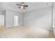 Spacious carpeted bedroom with a trey ceiling and fan fixture ready for relaxation and comfort at 2094 Harris Farm Ct, Burlington, NC 27215
