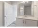 Bright bathroom featuring a single sink vanity, mirror, and a glimpse of a shower/tub at 2117 Treelight Way, Wendell, NC 27591
