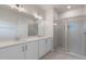 Modern bathroom featuring double sinks, quartz countertops, and a glass-enclosed shower at 2117 Treelight Way, Wendell, NC 27591
