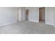 Neutral bedroom featuring carpet, white trim, and a view into the closet at 2117 Treelight Way, Wendell, NC 27591