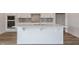 Island features quartz counters, sink, shaker cabinets, and tiled backsplash at 2117 Treelight Way, Wendell, NC 27591