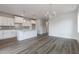 Open-concept kitchen with white cabinetry, stainless appliances, and hardwood flooring at 2117 Treelight Way, Wendell, NC 27591