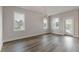 Bright living room featuring modern chandelier, gray walls, and beautiful hardwood floors at 2117 Treelight Way, Wendell, NC 27591