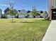 View of a new neighborhood with townhomes and manicured green spaces, enhanced by young trees at 2117 Treelight Way, Wendell, NC 27591
