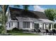 Rear view of the home, highlighting a spacious patio and a potential pool area at 2417 Bivins Rd, Durham, NC 27712