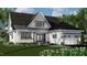 Two-story home showcasing a stylish exterior, landscaping, and a two-car garage at 2417 Bivins Rd, Durham, NC 27712
