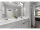 Double vanity bathroom with modern fixtures and grey tile floor at 263 Langdon Chase Way, Selma, NC 27576