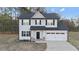 Two-story house with gray siding, black shutters, and a two-car garage at 263 Langdon Chase Way, Selma, NC 27576