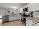 Modern kitchen with white cabinets, granite countertops, and stainless steel appliances at 263 Langdon Chase Way, Selma, NC 27576