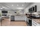 Modern kitchen with white cabinets, granite countertops, and stainless steel appliances at 263 Langdon Chase Way, Selma, NC 27576
