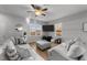 Living room with gray sofas, large TV, and hardwood floors, overlooking a yard at 263 Langdon Chase Way, Selma, NC 27576