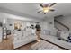 Spacious living room with gray sofas, a large TV, and hardwood floors at 263 Langdon Chase Way, Selma, NC 27576