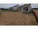 Exterior view of the house and backyard with newly installed sod and a covered porch at 46 Steppe Way, Garner, NC 27529