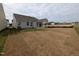 Rear exterior view showing the large backyard with newly installed sod and a covered porch at 46 Steppe Way, Garner, NC 27529