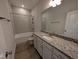 The bathroom features a granite vanity, tiled shower-tub, and modern fixtures at 46 Steppe Way, Garner, NC 27529