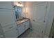 Stylish bathroom with granite counters, white cabinets, and a framed mirror over the vanity at 46 Steppe Way, Garner, NC 27529