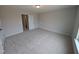 Neutral bedroom with carpeted floors and a view into an adjacent closet at 46 Steppe Way, Garner, NC 27529