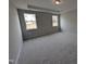 Spacious bedroom with neutral carpet, recessed lighting, and ample natural light from two windows at 46 Steppe Way, Garner, NC 27529