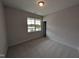 Bright bedroom with neutral carpet, a window offering natural light, and a closet for storage at 46 Steppe Way, Garner, NC 27529